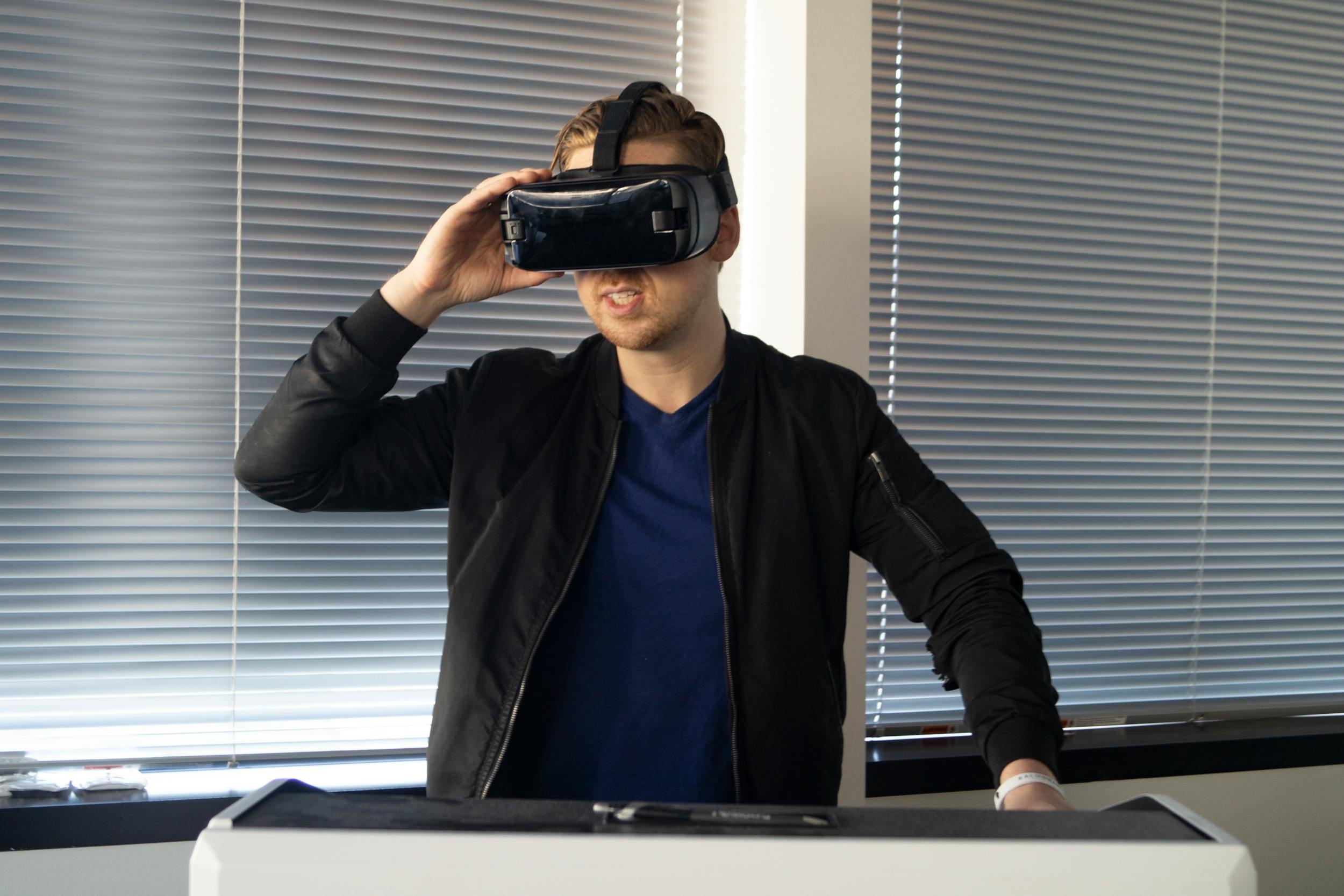 guy playing VR virtual reality fitness with blinds in background